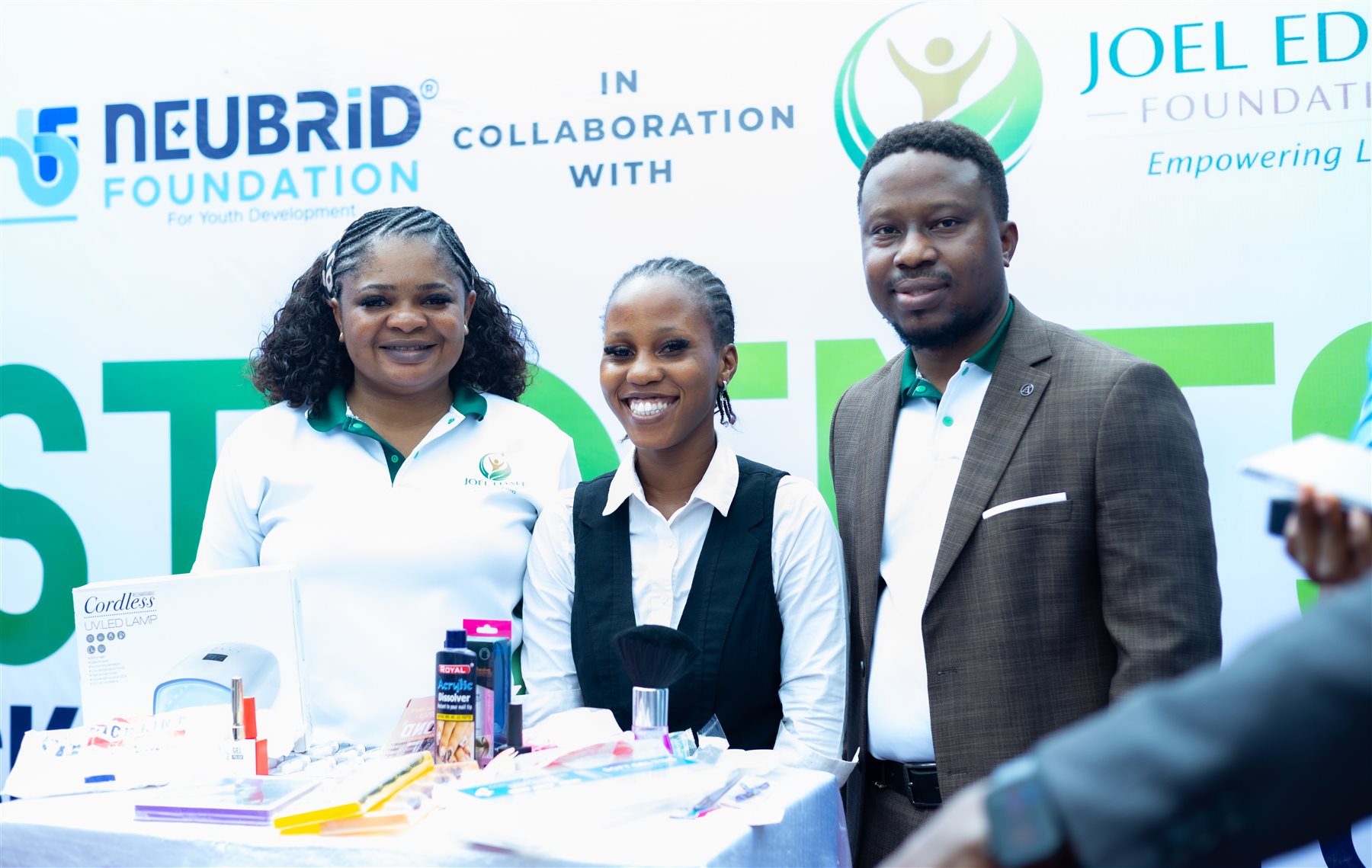 A participant with beauty-care equipment alongside foundation representatives
