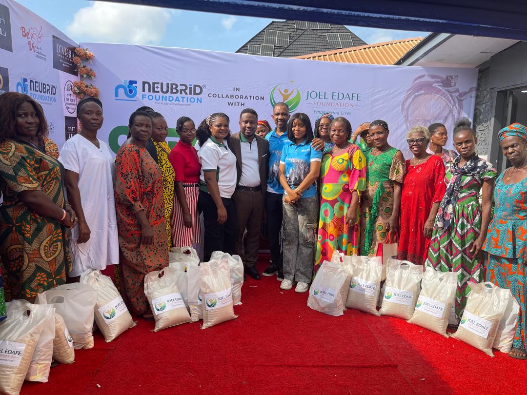 Community members gathered with food-support packages at a Joel Edafe Foundation outreach
