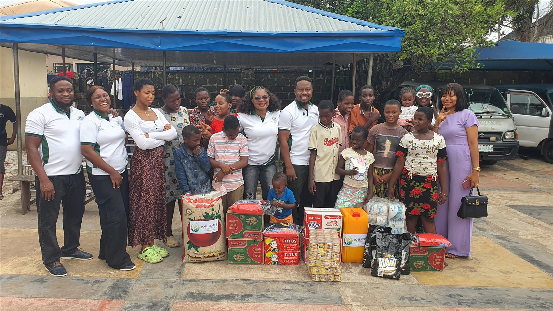 Foundation team and community members gathered with food and household supplies